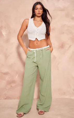 Pantalon en effet lin vert sauge à rayures contrastantes et cordons ajustables